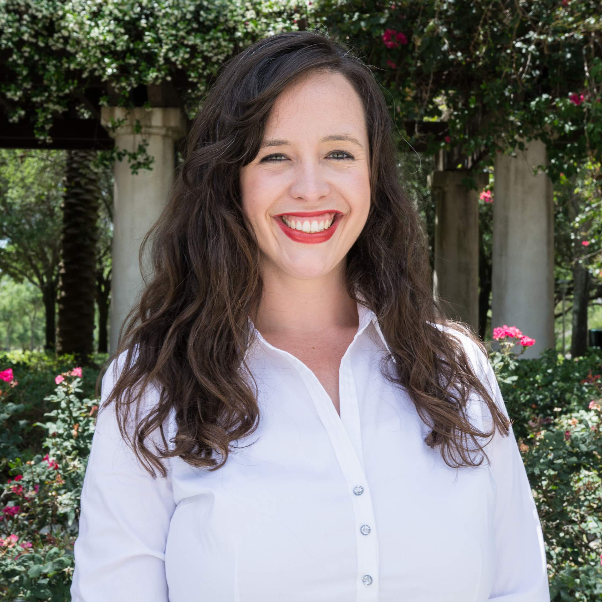 Audra Barkwell smiling with flowers in the background